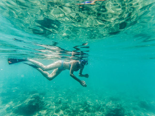 Fototapeta premium woman snorkeling in clear tropical waters - active holiday