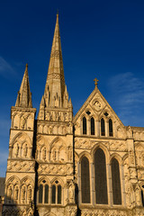 Fototapeta na wymiar Great West Front facade of Salisbury Cathedral with Spire in gold evening light in Salisbury England