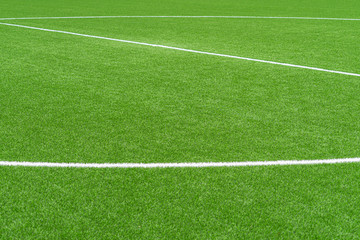 Fototapeta na wymiar Green artificial grass soccer sports field with white stripe line