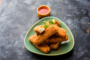 Kurkuri paneer fingers or pakora/pakoda snacks also known as Crispy Cottage Cheese Bars, served with tomato ketchup as a starter. selective focus