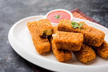 Kurkuri paneer fingers or pakora/pakoda snacks also known as Crispy Cottage Cheese Bars, served with tomato ketchup as a starter. selective focus