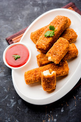 Kurkuri paneer fingers or pakora/pakoda snacks also known as Crispy Cottage Cheese Bars, served with tomato ketchup as a starter. selective focus