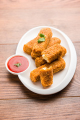 Kurkuri paneer fingers or pakora/pakoda snacks also known as Crispy Cottage Cheese Bars, served with tomato ketchup as a starter. selective focus