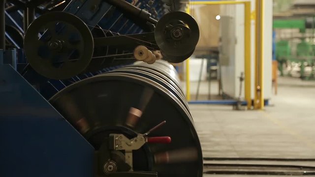 Tires production. Bronze wire is fed for the manufacture of the side rings of automotive wheels. Reinforced steel bronze wire side ring on the tire. Wire reinforcement of modern tires in a factory.