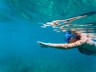 woman snorkeling in clear tropical waters - active holiday