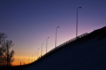 Fototapeta premium Road, evening, twilight, symmetry, silhouettes, sunset, lanterns, pillars, spring, loneliness, soul, silence