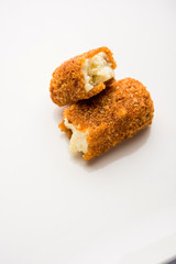 Kurkuri paneer fingers or pakora/pakoda snacks also known as Crispy Cottage Cheese Bars, served with tomato ketchup as a starter. selective focus