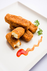 Kurkuri paneer fingers or pakora/pakoda snacks also known as Crispy Cottage Cheese Bars, served with tomato ketchup as a starter. selective focus