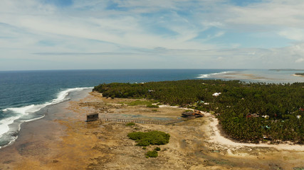 Aerial view of wooden walkway for surfers to cross the reef of siargao island to cloud 9 surfspot. Summer and travel vacation concept