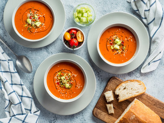 Gaspacho soup on white marble tabletop. Three bowls of traditional spanish cold soup puree gaspacho...