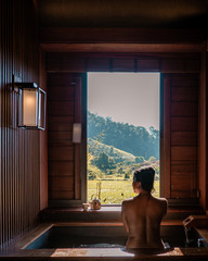 Onse wooden bath tub,Woman enjoys bath at hot springs in Chiang Mai Thailand, Onsen Japanese Bath