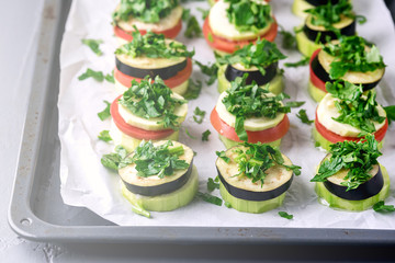 Piles of Raw Eggplants Zucchini Tomatoes Decorated with Chopped Parsley on Baking Tray Ready to Grill or Roast Vegetarian Snack Vegan Diet Healthy Dish