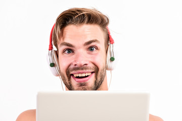 Guy with headphones and laptop. Student life. Online entertainment. Education opportunities. Gadget making life much easier. Leisure and fun. Portable gadget. Man use modern technologies gadget