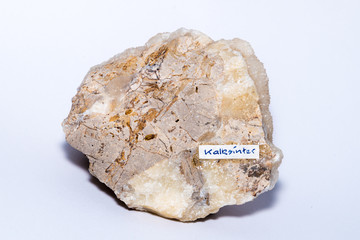 Calc sinter white gemstone formed on an usual piece of bed rock isolated