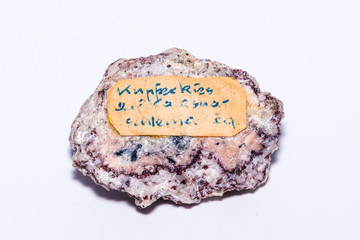 Chalcopyrite pyrite gem with labell containing high amounts of copper ore isolated