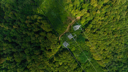 Aerial view. High voltage metal post. High-voltage towers in the forest.