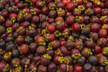 Pile of fresh mangosteen for sale at tropical fruit market