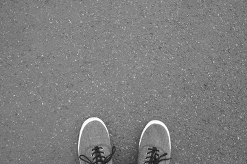 feet in canvas shoes standing on street - foot selfie from personal perspective point of view -...