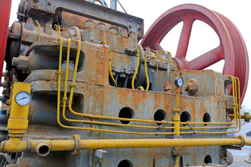 abandoned large mechanical equipment wheel and lines