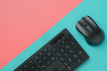Top view black computer keyboard and mouse on a colorful background with copy space