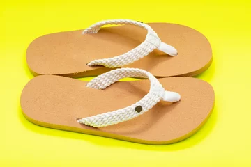 Stof per meter Women's Causal Braided natural color Beach Day Flip Flops isolated on bright yellow background. © bjphotographs