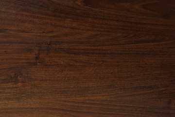 Polished wood texture. The background of polished wood texture with a dark amber color