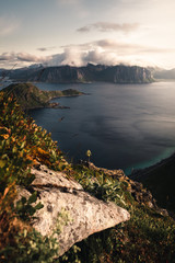a man standing on the edge watching sunset