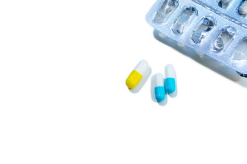 blue capsules and empty blister on white background