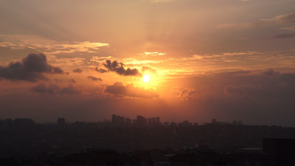 Fototapeta premium Beautiful panoramic colorful sunset on the cloudy sky over city, Turkey