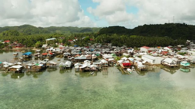 Village of stilt houses built over the sea, top view. Dapa, Siargao, Philippines.