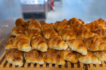 Pile of tasty croissants for sale at pastry shop
