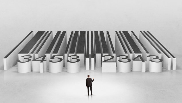 Young businessman standing in front of a big codebar