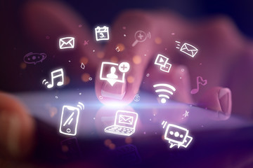 Finger touching phone with hologram application icons and dark background