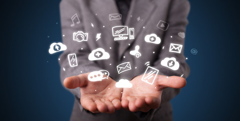 Hand holding application icons and symbols in her hand