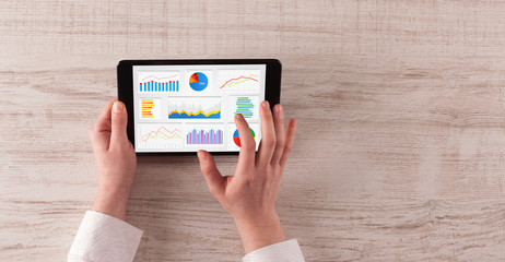 Hand making diagrams and charts on tablet