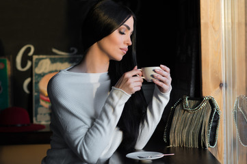 elegant brunette with cup of coffee