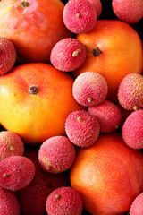 Metal box with tropic fruits, Lychee (Litchi) and mango