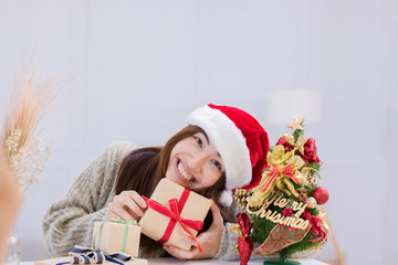Smiling young woman and Christmas present box.