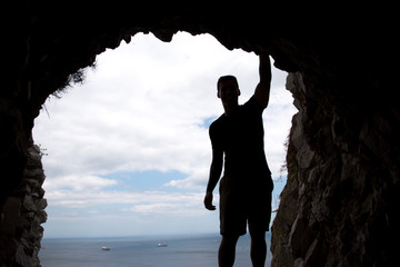 Silhouette of a man overlooking the Straight of Gibraltar from a tunnel in the Rock of Gibraltar