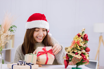 Smiling young woman and Christmas present box.
