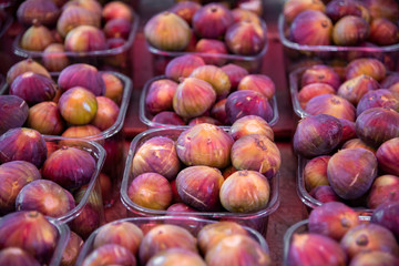 Ripe figs for sale at the city farmers market. Background of ripe juicy figs on the market stalls shot close-up. Carmel Market, Tel Aviv, Israel