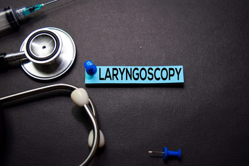 Laryngoscopy text on Sticky Notes. Top view isolated on black background. Healthcare/Medical concept
