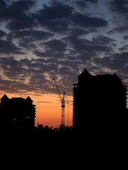 Fototapeta premium tower crane work, in the evening on the construction site