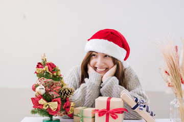 Smiling young woman and Christmas present box.