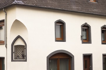 Fototapeta na wymiar White gothic house with black roof tiles (Germany, Europe)