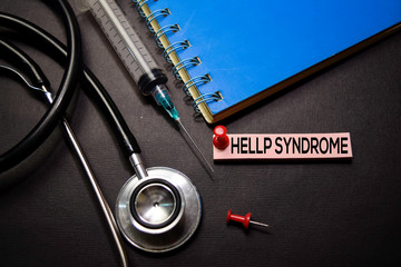 HELLP Syndrome text on Sticky Notes. Top view isolated on black background. Healthcare/Medical...