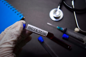 Venous Blood Gas text on Sticky Notes. Top view isolated on black background. Healthcare/Medical concept