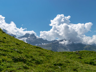 Naklejka premium high mountain peaks covered in mystic fog on a scenic day in summer, Switzerland 