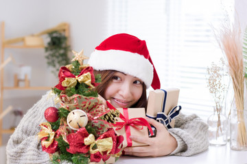 Smiling young woman and Christmas present box.