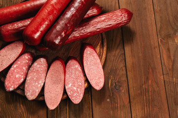 smoked sausage on wooden background